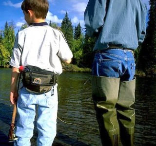 Alaska. Fairbanks. A father and son fishing catch/release for grayling on the Upper Chena River. MR.